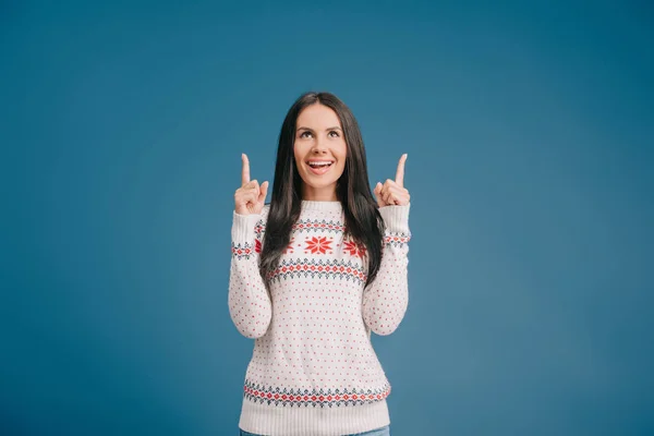 Happy Girl Winter Sweater Pointing Something Isolated Blue — Stock Photo, Image
