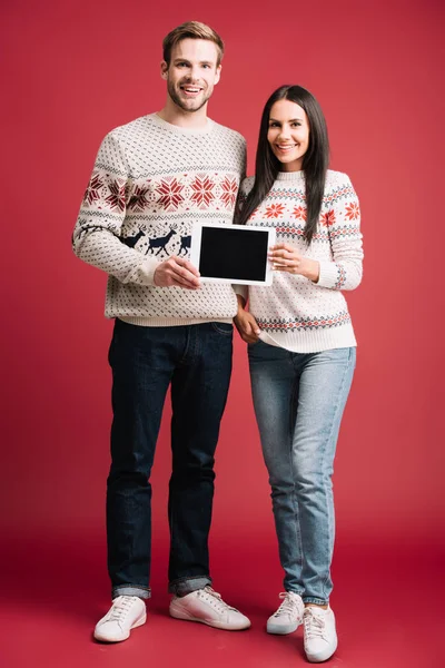 Beautiful Couple Sweaters Presenting Digital Tablet Blank Screen Isolated Red — Stock Photo, Image