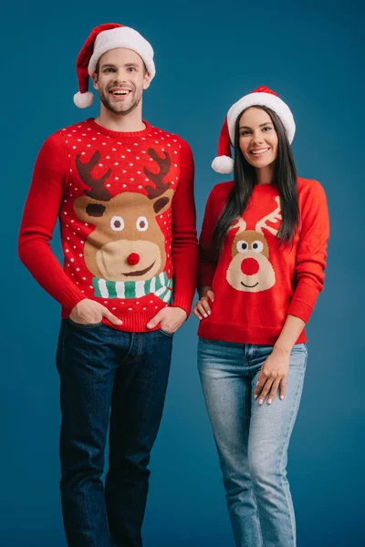 Happy Couple Posing Santa Hats Sweaters Isolated Blue — Stock Photo, Image