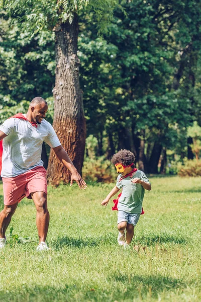 Happy African American Father Son Running Costumes Superheroes Park — 스톡 사진