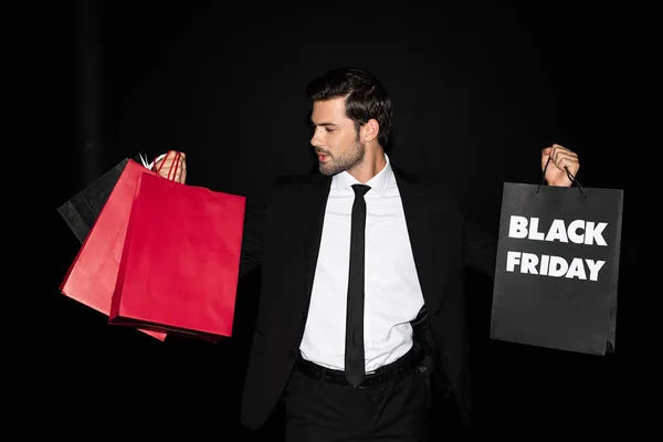 Elegant Man Holding Shopping Bags Black Friday Sign Isolated Black — Stock Photo, Image