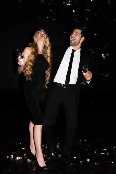 Excited Young Couple Celebrating Champagne Black Golden Confetti — Stock Photo, Image