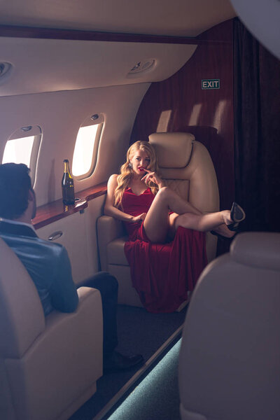 beautiful elegant sexy couple sitting in airplane 