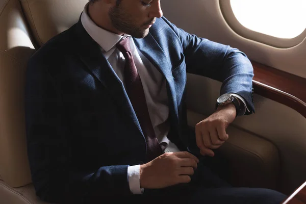 Pensive Businessman Looking Watch While Sitting Airplane — Stock Photo, Image