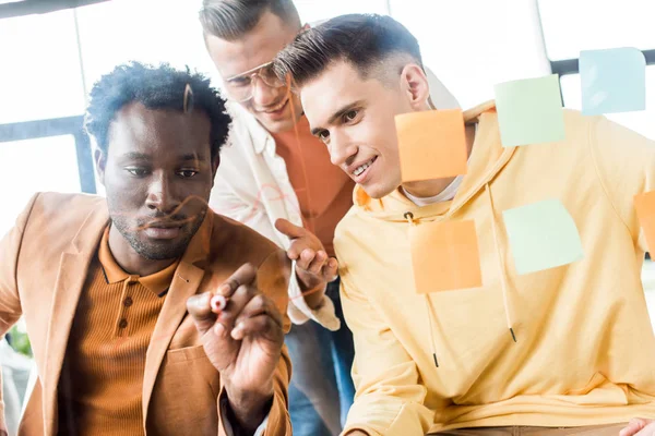 African American Businessman Writing Glass Board While Working Colleagues Office — Stock Photo, Image