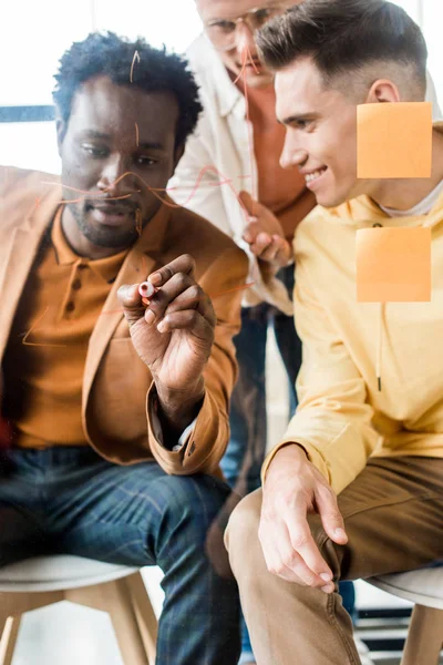 African American Businessman Writing Glass Board While Working Colleagues Office — Stock Photo, Image