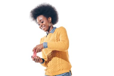 cheerful african american girl playing video game with joystick, isolated on white