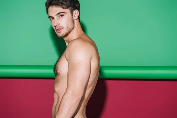 Sexy Hombre Sin Camisa Mirando Cámara Verde Rojo Fondo — Foto de Stock