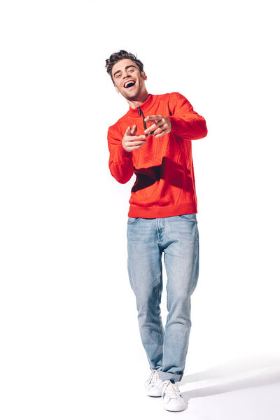 handsome man laughing and pointing at you, isolated on white