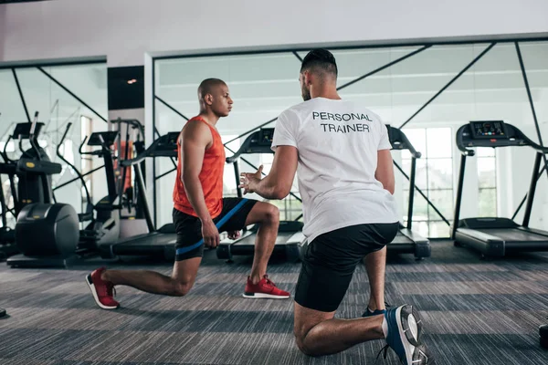 Back View Personal Trainer Instructing African American Sportsman Exercising Resistance — Stock Photo, Image