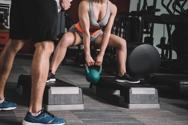 Cropped View Personal Trainer Standing Sportswoman Lifting Weight Gym — Stock Photo, Image