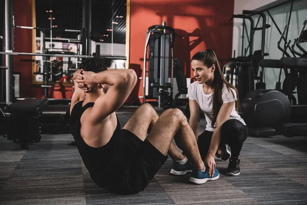 Attentive Trainer Supporting Handsome Sportsman Doing Push Ups — Stock Photo, Image