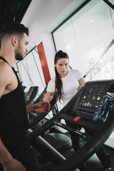 Attractive Trainer Instructing Young Sportsman Standing Treadmill — Stock Photo, Image