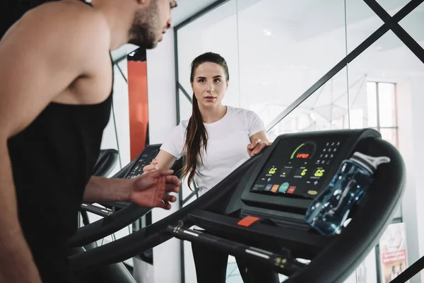 Attentive Trainer Looking Sportsman Running Treadmill — Stock Photo, Image