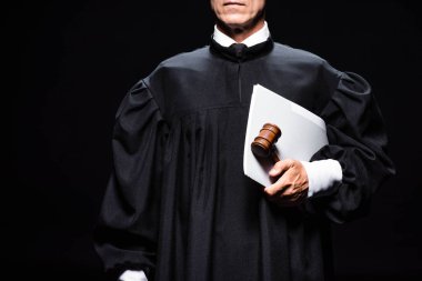cropped view of judge in judicial robe holding gavel and papers isolated on black  clipart