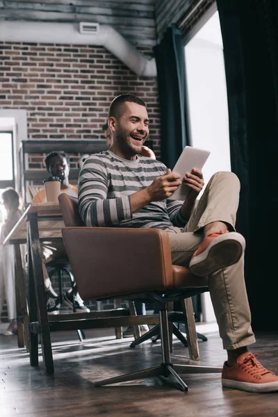 Fröhlicher Geschäftsmann Mit Digitalem Tablet Sessel Neben Afrikanischem Amerikanischen Kollegen — Stockfoto