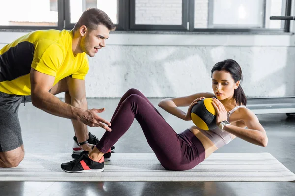 Sportswoman Doing Crunches Ball Sportsman Helping Her Sports Center — Stock Photo, Image