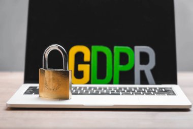 Dizüstü bilgisayardaki metal asma kilit ve GDPR harflerinin seçici odağı 