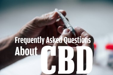 cropped view of man holding blunt of medical cannabis with frequently asked questions about cbd illustration clipart