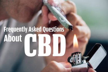 cropped view of man lighting up blunt with medical cannabis and frequently asked questions about cbd illustration clipart