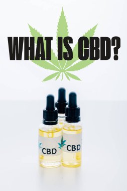 cbd oil in bottles isolated on white with what is CBD question clipart