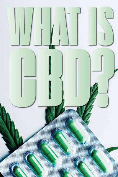 top view of green pills in blister and marijuana leaf on white background with what is CBD question