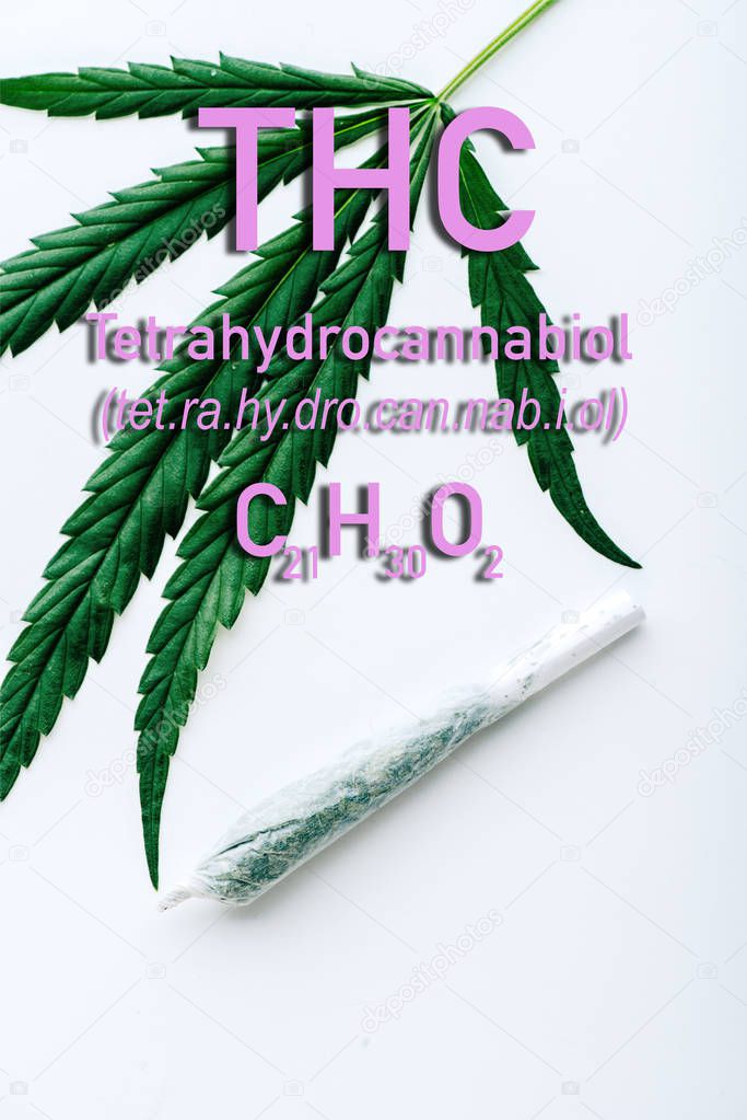 top view of medical marijuana leaf and joint on white background with thc formula illustration