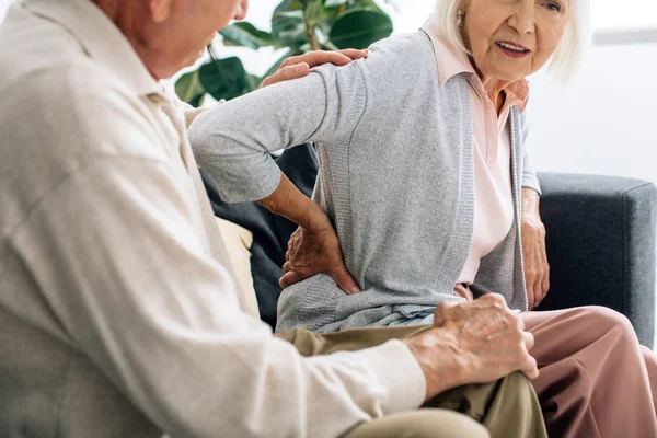 Cropped View Husband Looking Wife Back Pain Apartment — Stock Photo, Image