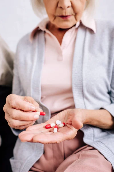 Cropped View Senior Woman Sitting Sofa Holding Pills Apartment — Stock Photo, Image