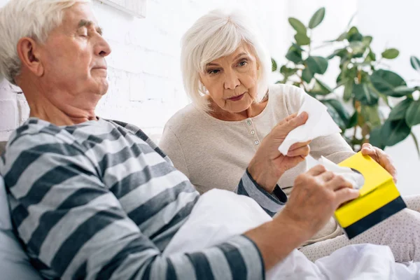 Attractive Wife Giving Napkins Ill Husband Bed — Stock Photo, Image