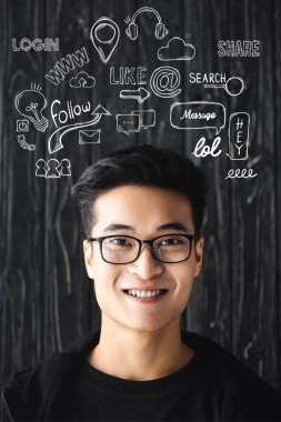 smiling asian man in glasses looking at camera on wooden background with illustration   clipart