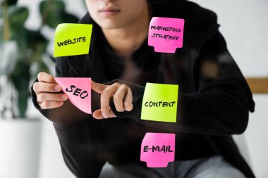 Seo yöneticisinin cam üzerine seo illüstrasyonla kağıt yapıştırdığı kırpılmış görünüm 