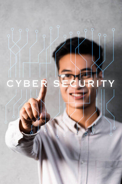 selective focus of asian businessman touching illustration with cyber security lettering 