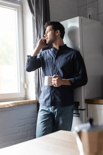 Handsome Man Holding Cup Coffee While Talking Cellphone Kitchen Quarantine — Stock Photo, Image
