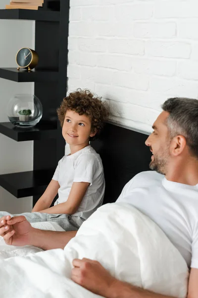 Selective Focus Curly Boy Smiling Bearded Father Bedroom — Stock Photo, Image