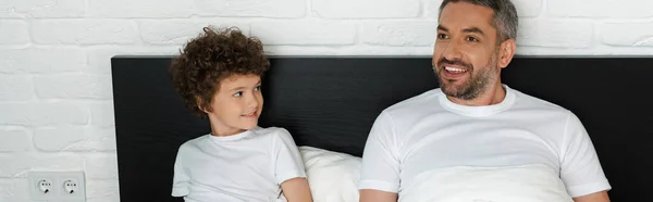 Panoramic Shot Curly Boy Looking Bearded Father Bedroom — Stock Photo, Image