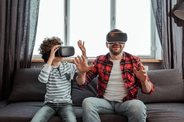 Bearded Father Curly Son Virtual Reality Headsets Gesturing Living Room — Stock Photo, Image