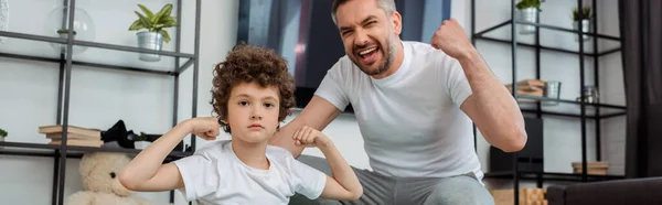 Panoramic Shot Happy Father Cheering Curly Son Showing Muscle — Stock Photo, Image