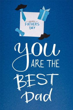 top view of greeting card with lettering happy fathers day and paper craft creative decorating elements on blue background, you are the best dad illustration clipart