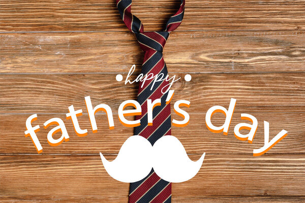 Top view of mens striped fabric tie on wooden background, happy fathers day illustration