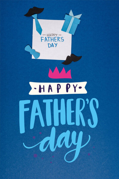 top view of greeting card and paper craft creative decorating elements on blue background, happy fathers day illustration