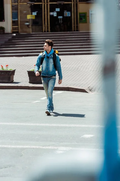 道路横断歩道を歩くバックパック付き宅配便の選択的な焦点 — ストック写真