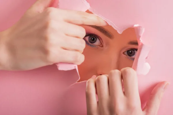 Beautiful Woman Shiny Makeup Looking Paper Torn Hole Isolated Pink — Stock Photo, Image