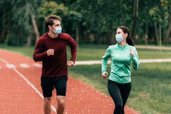 Jovem Casal Máscaras Médicas Jogging Pista Corrida Parque — Fotografia de Stock