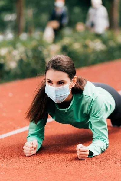 Jovem Desportista Máscara Médica Fazendo Prancha Durante Treinamento Parque — Fotografia de Stock