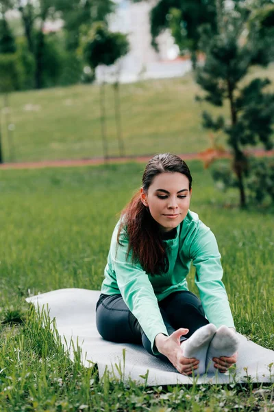 Selective Focus Beautiful Sportswoman Stretching While Sitting Fitness Mat Grass — Stock Photo, Image