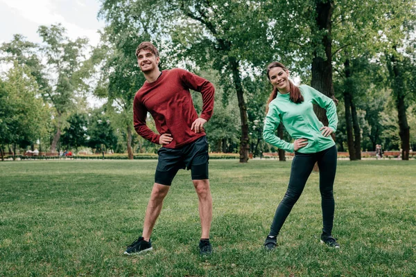 Young Couple Smiling While Exercising Together Park — Stock Photo, Image