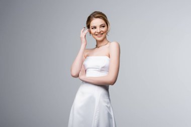 Gelinlikli neşeli gelin, gri saçlara dokunuyor. 