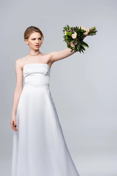 Dissatisfied Bride White Dress Looking Wedding Flowers Isolated Grey — Stock Photo, Image