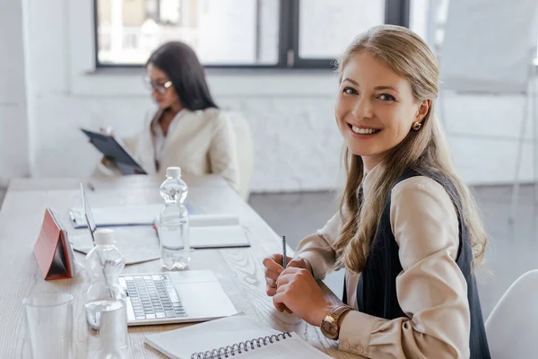 Selective Focus Happy Businesswoman Looking Camera Laptop Coworker Office — Stock Photo, Image